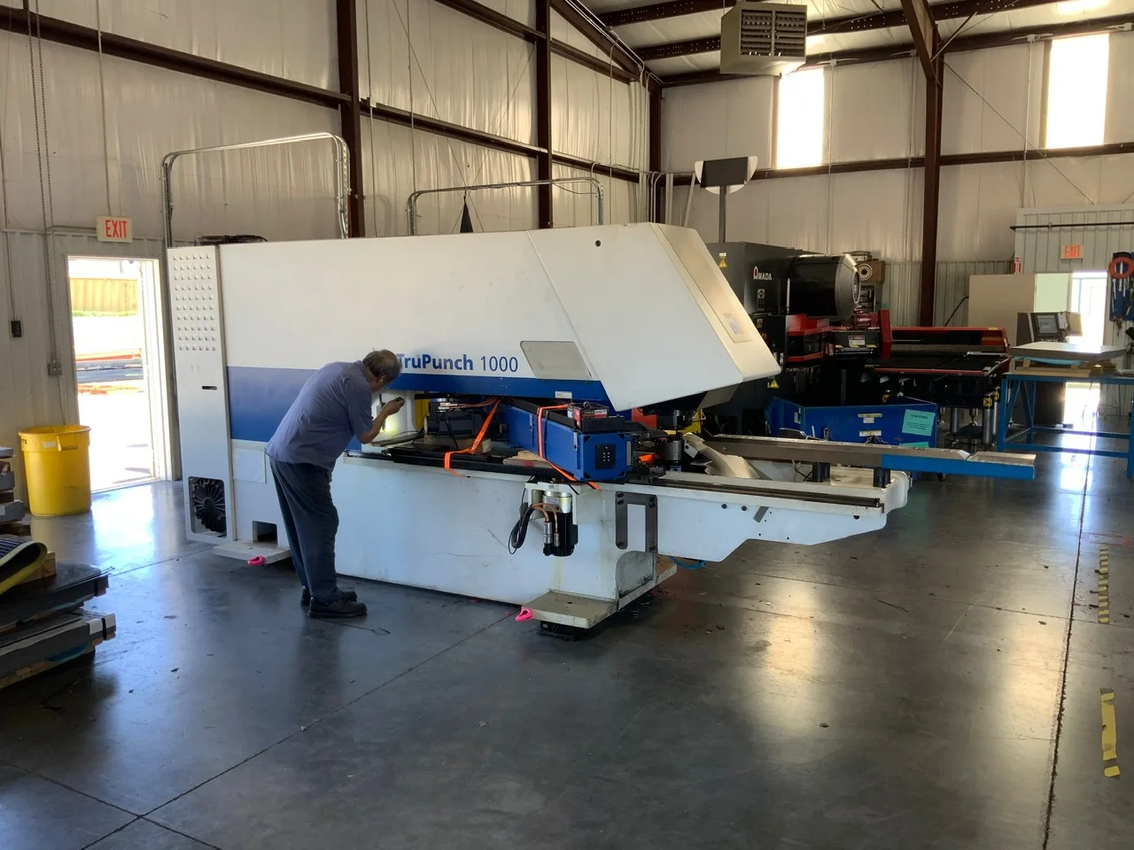 Technician working on a CNC machine during relocation support